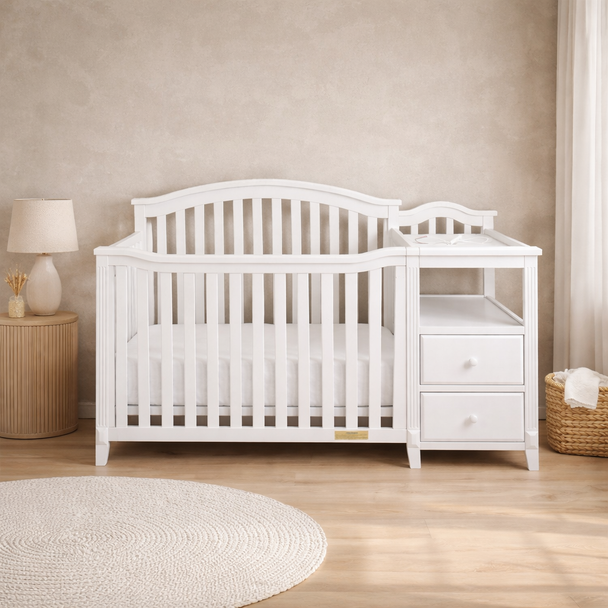 White crib and changing table set in a nursery with wooden floor and beige walls.