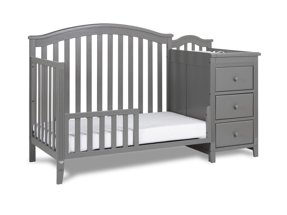 Gray crib with changing table on a white background