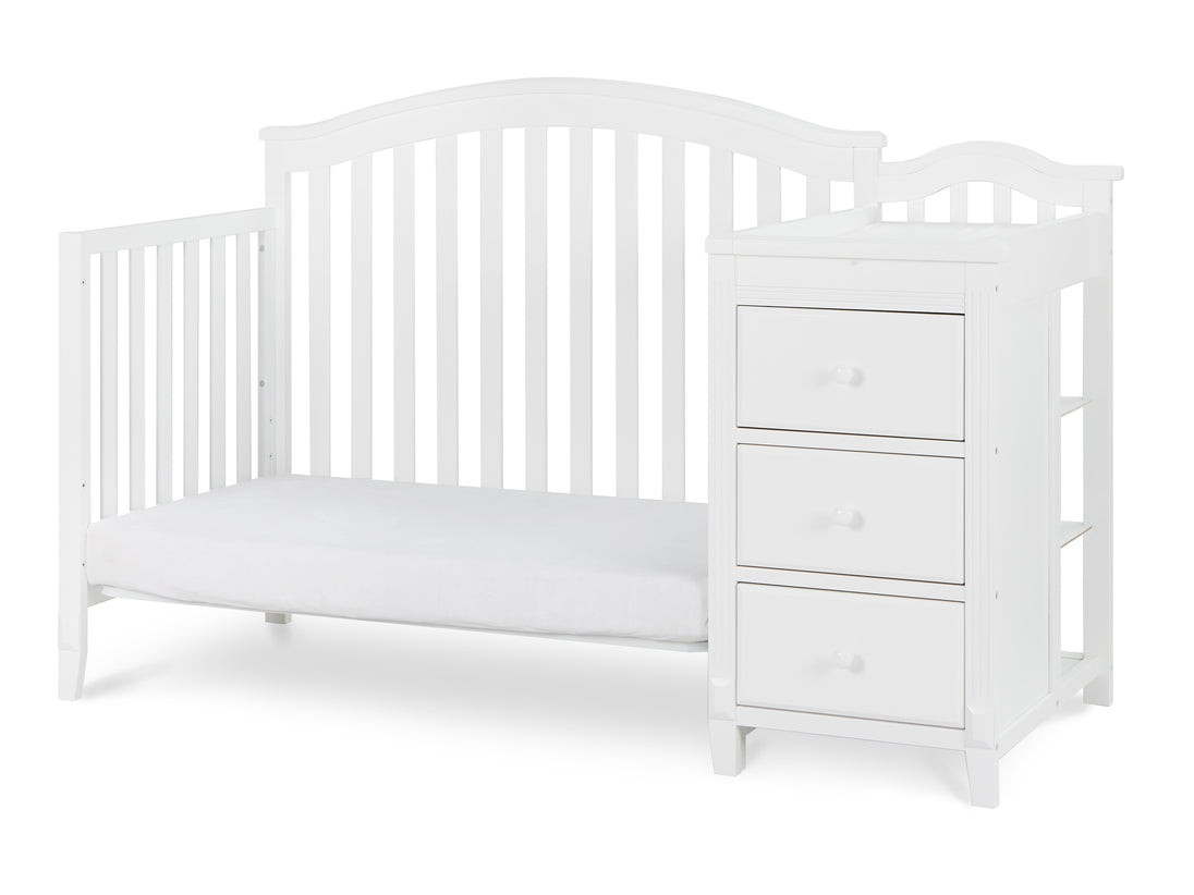 White crib with drawers on a white background