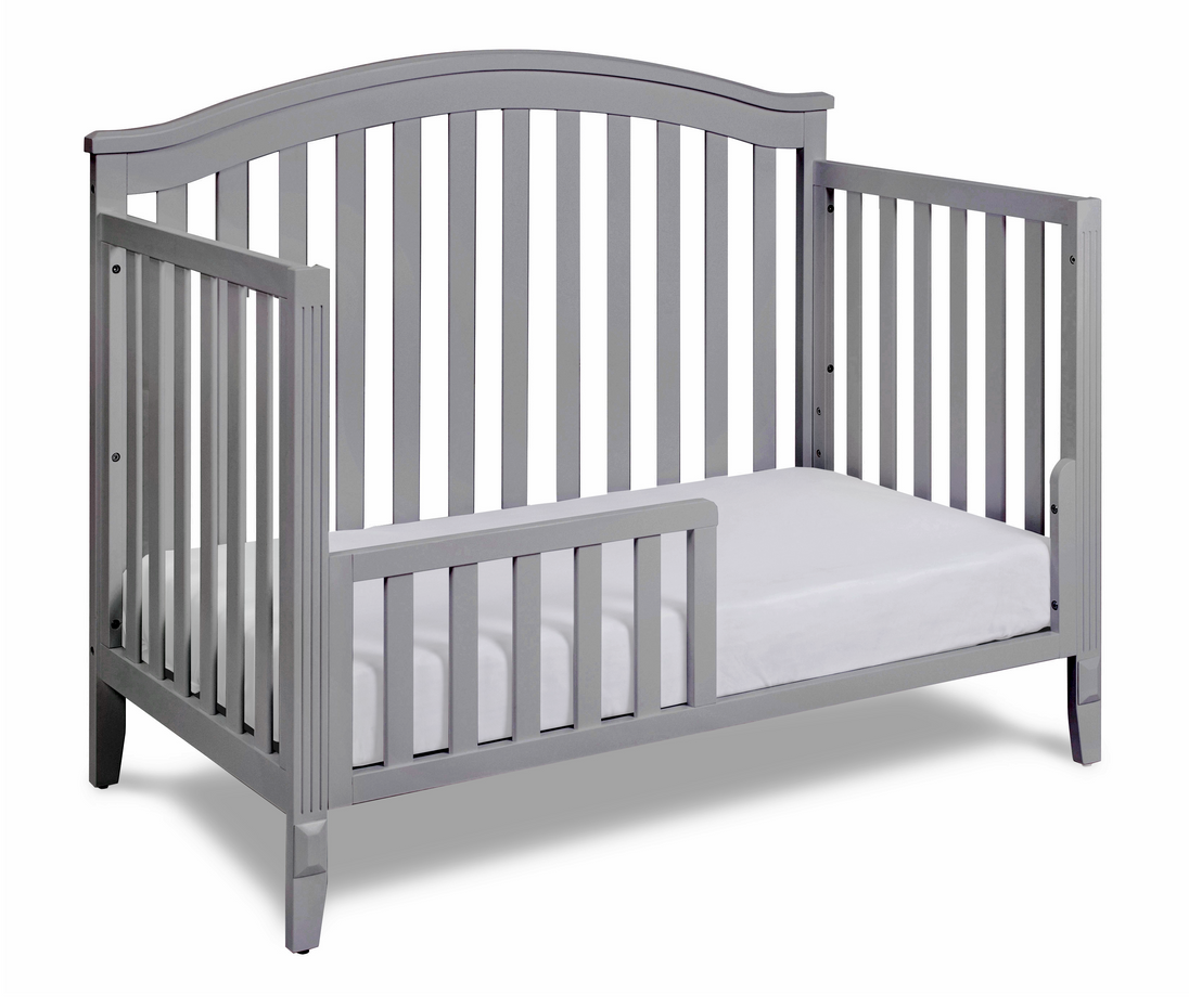 Gray crib with a white mattress on a white background