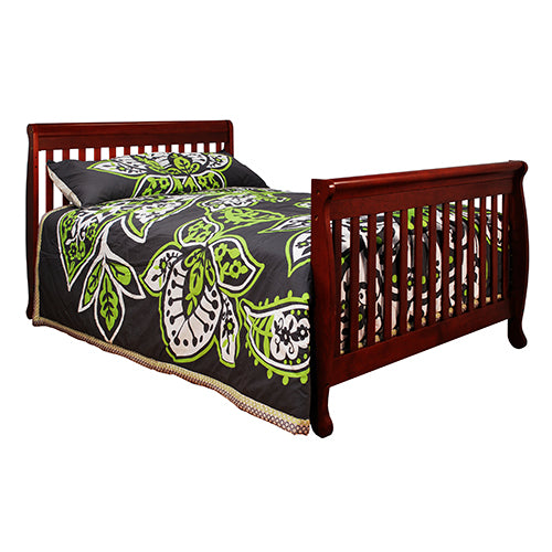Bed with a dark green and white patterned comforter on a white background