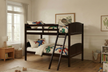 Children's room with a wooden bunk bed, toys, and furniture.