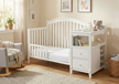 Nursery room with a white crib and changing table.